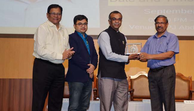 Registrar Premakumar presenting the memento to Dr. Nagmare